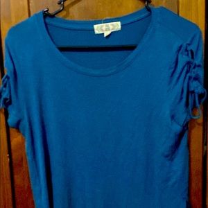 Womens blue top with lace style tied above shoulders